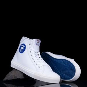 Clean white sneakers on black background with blue soles from Broxx brand.